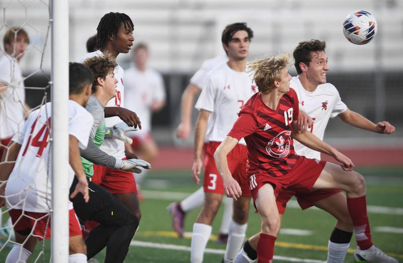 Naperville Central’s Michael Cavalleri, left, and Hinsdale Central’s Owen Peterson battle in front of the net in the Class 3A East Aurora supersectional boys soccer game on Tuesday, November 1, 2022.