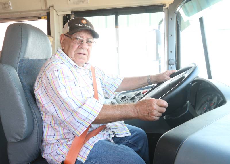 Authur Simpson poses for a photo behind the wheel of a school bus on Monday, July 28, 2025 at the Streator-Woodland Bus Company. The Simpsons have a combined 101-years of driving a school bus.