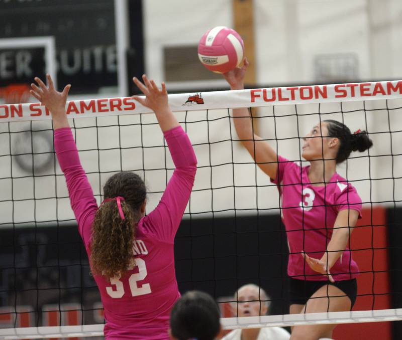 Fulton's Kerby Germann (3) spikes the ball as Eastland's Keara Kaus (32) jumps to block during Tuesday, Oct. 7, 2025 action in Fulton.