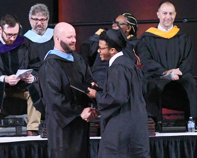 DeKalb High School senior Travis Gooden is all smiles as he receives his diploma on Saturday, May 24, 2025, during the Class of 2025 Commencement ceremony held at the Convocation Center in DeKalb.