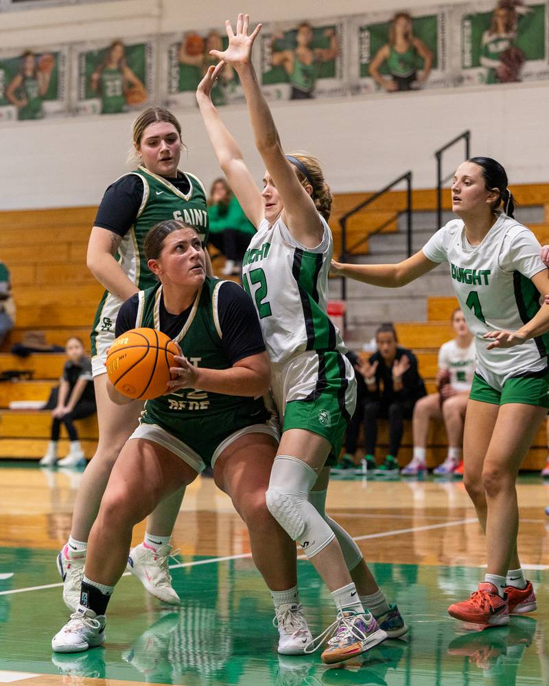 Ava Balestri (52) of St. Bede holds ball before going up for shot in paint whilst being guarded by Dwight's Mikayla Chambers (12) on Monday, January 19, 2026 at the Krese Memorial Gymnasium in Dwight.