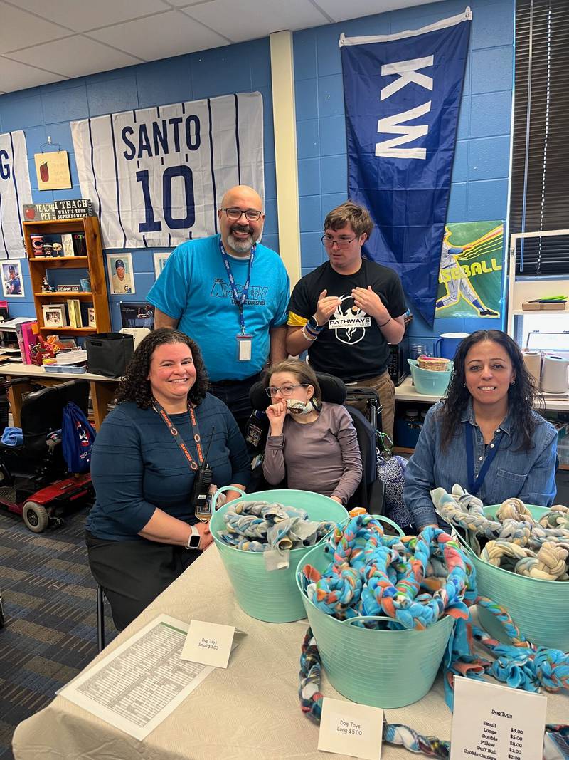 Oswego School District 308 Superintendent Andalib Khelghati, far left, and Dist. 308 staff and students at one of the Pathways Transition Center's craft show.