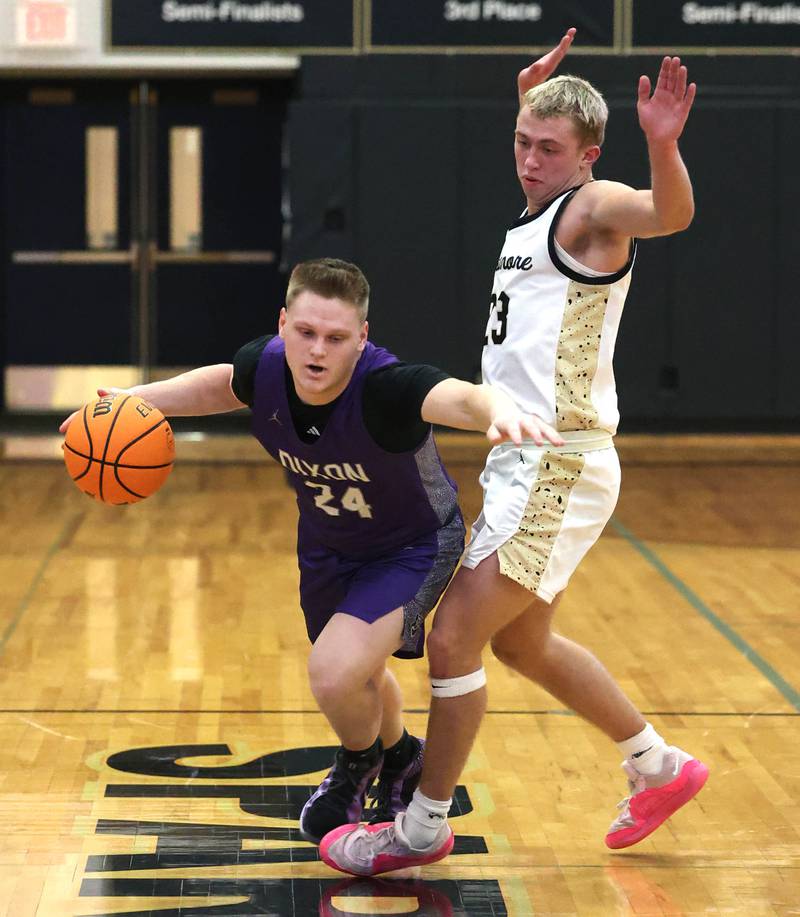Dixon’s Eli Davidson dribbles by Sycamore's Carter York during their game Tuesday, Jan. 14, 2025, at Sycamore High School.