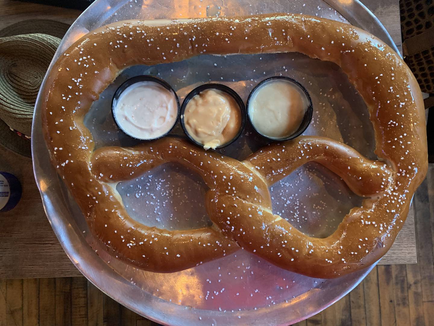 The Richmond Brat Haus’ signature Colossal Bavarian Pretzel ($20) with bier cheese, garlic aioli and honey mustard dipping sauces.