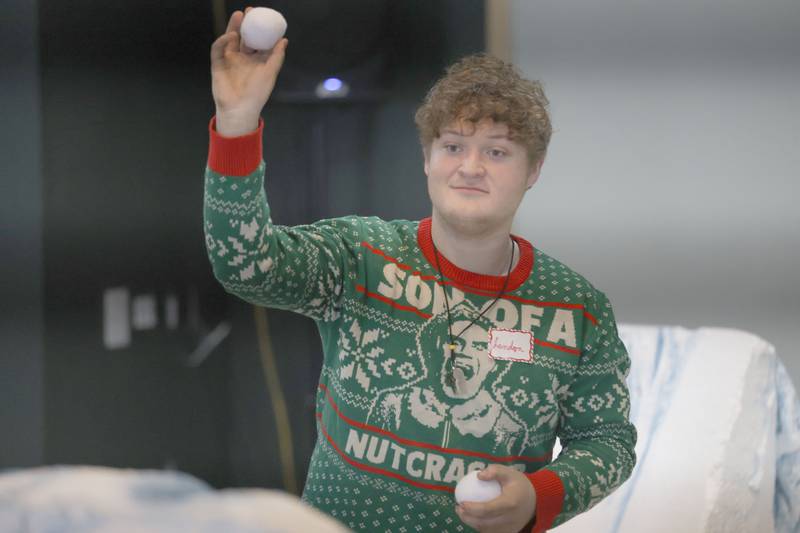 Landon Harris throws snowballs during the Miracle on First Street at Ax Church on Saturday, Dec. 6, 2025 in La Salle.