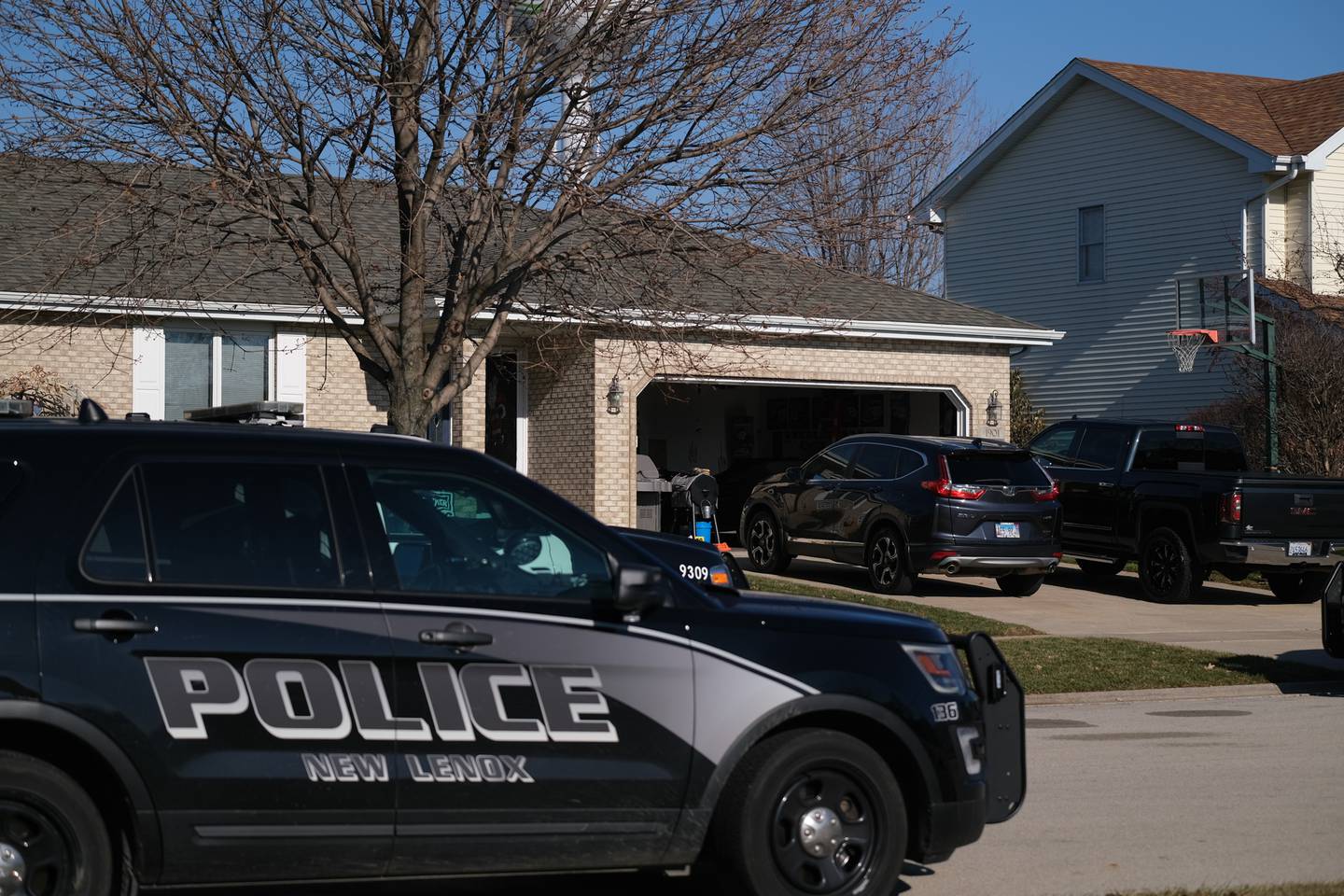 New Lenox police sit in front of the home at the 1900 block of Grand Prairie Driver. A 21-year old man shot his father at the home on Grand Prairie Drive in New Lenox early Monday morning. Monday, Dec. 20, 2021 in New Lenox.