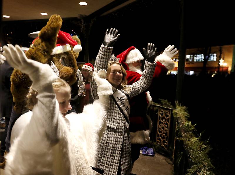 Little Miss Woodstock McKenna, WoodstockWillie, Miss Woodstock 2023 Maggie Adams and Santa Claus wave to the crowd during the Lighting of the Square Friday, Nov. 24, 2023, in Woodstock. The annual holiday season event featured brass music, caroling, free doughnuts and cider, food trucks, festive selfie stations and shopping.