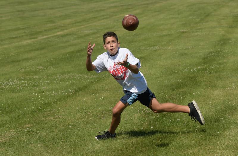 Gavin Stevenson, 13 makes a diving catch during the inaugural Legends of the 60115 Football Camp in DeKalb on Sunday, June 26, 2022.