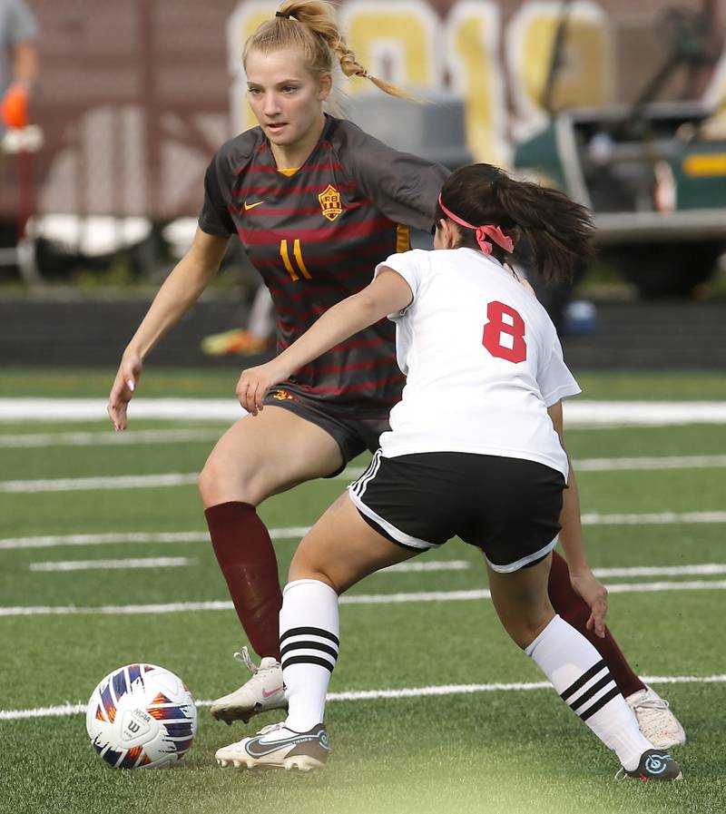 Richmond-Burton's Margaret Slove controls the ball in front of Woodlands Academy’s Faith Guerra during a IHSA Division 1 Richmond-Burton Sectional semifinal soccer match Tuesday, May 16, 2023, at Richmond-Burton High School.