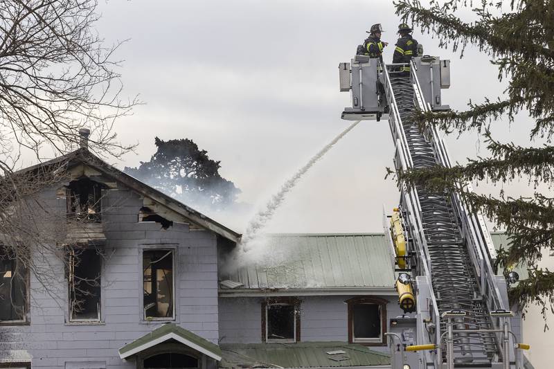 Water is poured on a fire Monday, April 14, 2025, on Harmon Road.