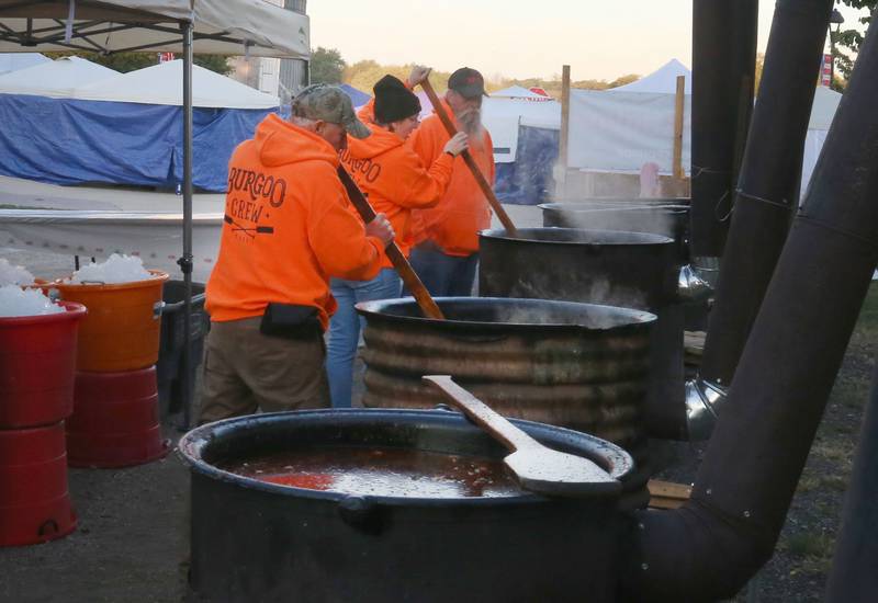 Volunteers stir the Burgoo in large 40-gallon kettles during the 55th annual Burgoo Festival on Sunday, Oct. 12, 2025 in Utica.