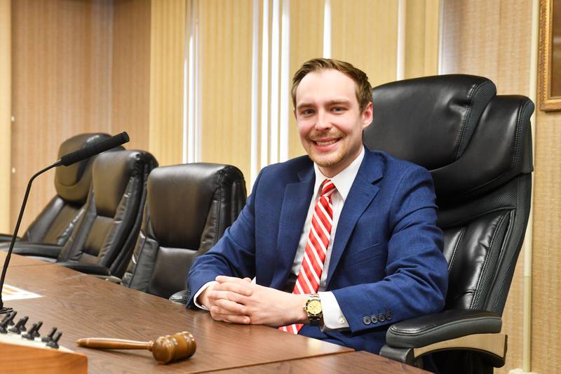 Kankakee County Board chairman Matthew Alexander-Hildebrand, 27, sits in his chair in the board room on Feb. 4, 2025. Alexander-Hildebrand, of Bourbonnais, became the youngest person elected to the position in December after winning reelection to his board seat in November.