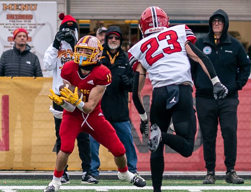 Batavia’s Gerke Drew (11) catches a pass against Yorkville's Luke Zook (23) during a 7A quarterfinal playoff football game at Batavia High School on Saturday, Nov 12, 2022.