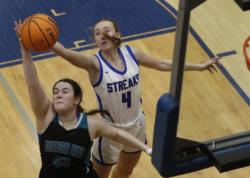 Woodstock North's Brenna McConnell tries to grab a rebound in front of Woodstock's Lily Novelle during a Kishwaukee River Conference basketball game on Friday, Jan. 10, 2025, at Woodstock High School.