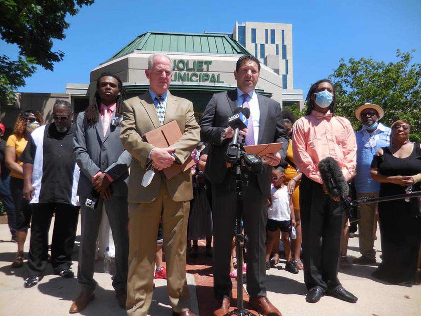 Attorneys Lawrence X. O'Reilly (left) and Michael E. Baker stand in the foreground, flanked by their clients, Victor Williams (left) and Jamal Smith at a news conference outside Joliet City Hall on Monday. Williams and Smith, who are brothers, were arrested after Williams was confronted and grabbed by Joliet Mayor Bob O'Dekirk at a May 31 Black Lives Matter demonstration.