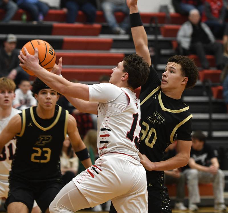 Forreston's Kendall Erdmann drives past Pecatonica's Izaiah Braimah on Wednesday, Feb. 11, 2026 at Forreston High School.
