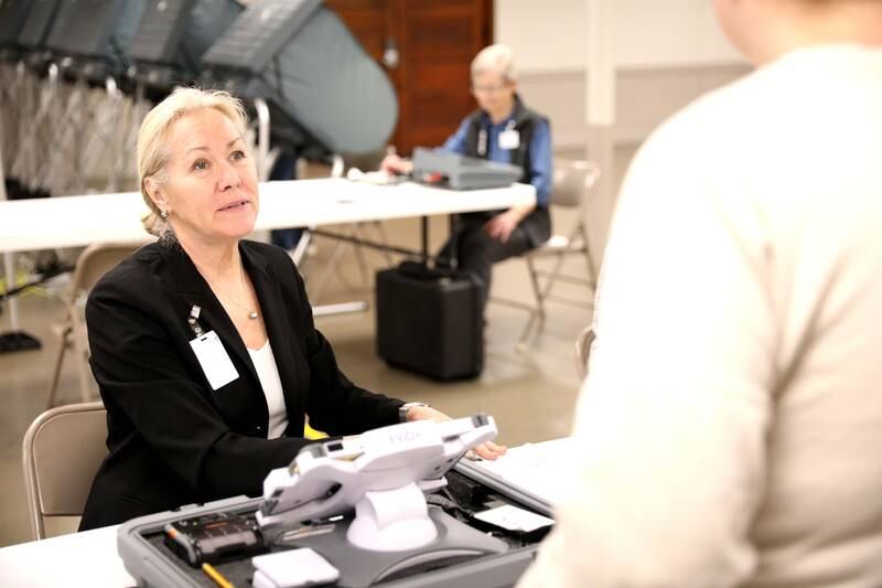 Election Judge Naomi Rolfe helps voter Laura Furgason for the Consolidated Election on Tuesday, April 4, 2023 at the Sugar Grove Township Community Center.