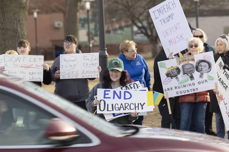 Alicia Montanez displays signs Tuesday, Feb. 25, 2025, during a demonstration in Sterling. Montanez is especially frustrated with how the Trump administration has been handling immigrants.