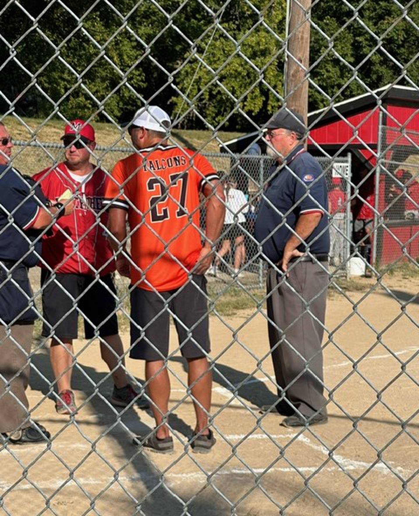 David Elliott (on right) of Marseilles umpired his final game recently after 25 years of service in the community and around the Illinois Valley.