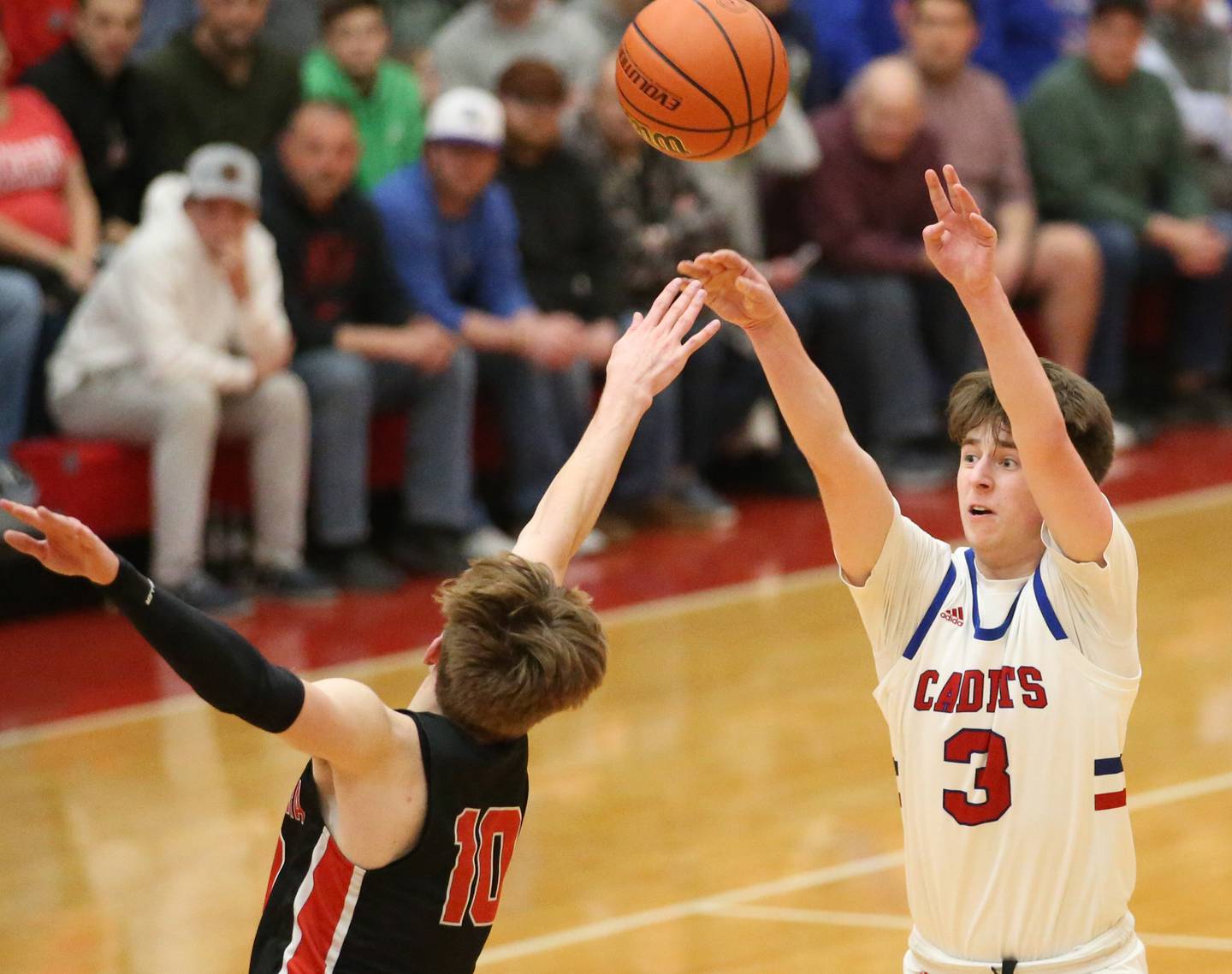 Marmion's Collin Wainscott shoots a three point basket over Metamora's Tyler Mason during the Class 3A Super-Sectional on Monday, March 6, 2023 at Ottawa High School.