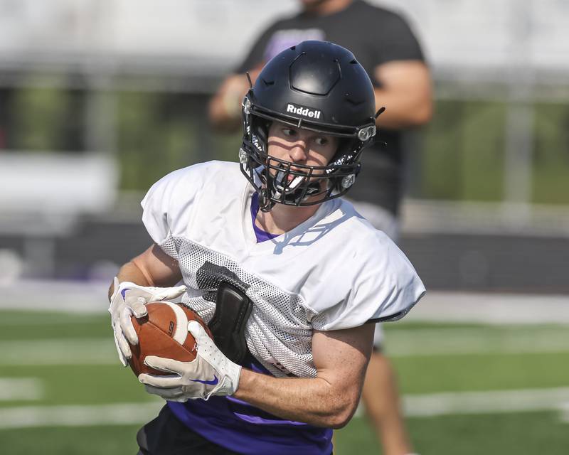 Max Troha turns to run after making a catch at Downers Grove North High School football practice, Thursday, Aug 14, 2025  in Downers Grove.