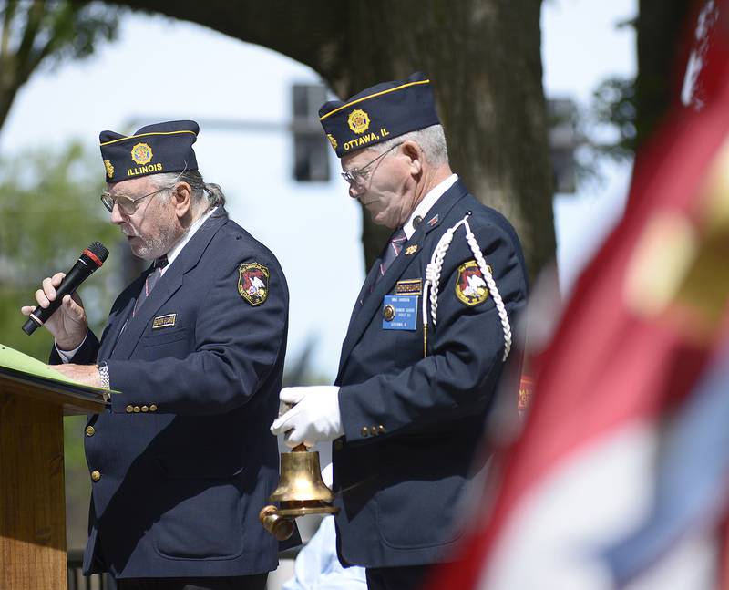 Members of American Legion Post 33 read the names and ring a bell  on behalf veterans who passed away this past year during the Memorial Day ceremony at Washington Park in Ottawa Monday.