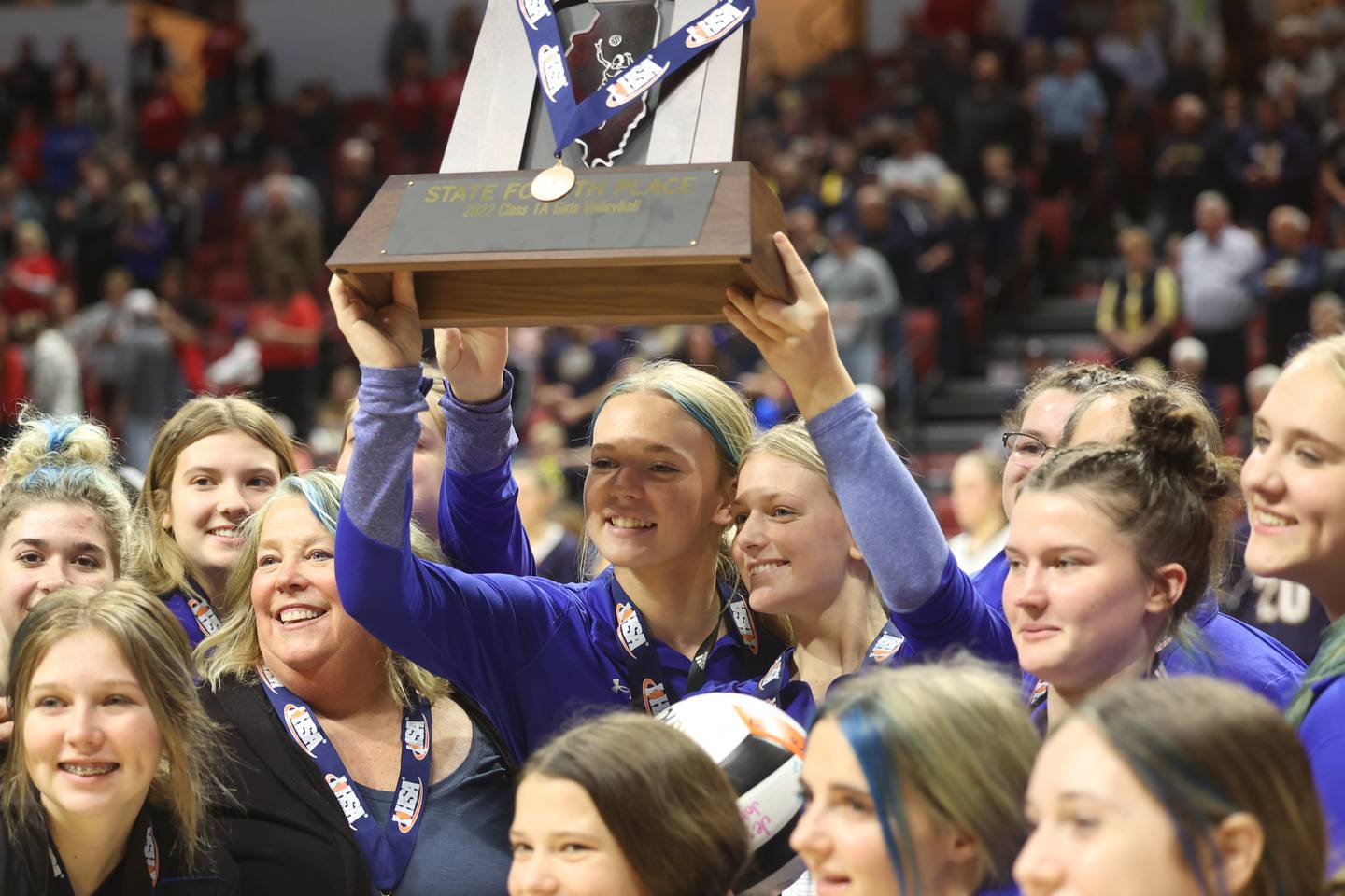 Newman receives the fourth-place trophy Saturday at Normal's CEFCU Arena.