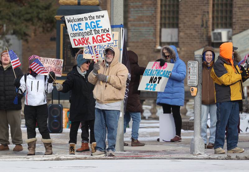 Protesters gather Tuesday, Jan. 20, 2026, at Memorial Park on the corner of First Street and Lincoln Highway in DeKalb as part of a national Free America Walkout. The group is protesting what they perceive as an escalating fascist threat under President Donald Trump and his administration.