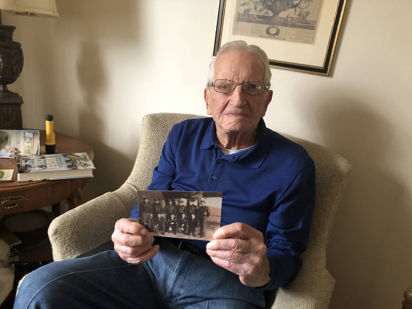 Edward “Bud” Berthond, who turns 103 later this month, shows a photo of the day he received his pilot wings 79 years ago. Sen. Tammy Duckworth stopped in to wish him a happy birthday on Friday, Nov. 4, 2022.