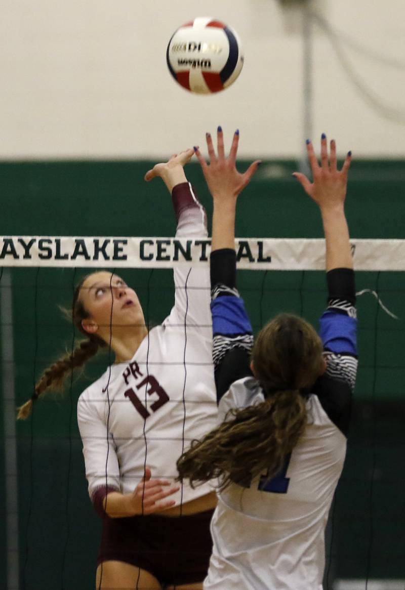 Prairie Ridge's Abigail Smith hits the ball as St. Francis' Mackenzie Krzus tries to block the ball during the IHSA Class 3A Grayslake Central Supersectional volleyball match on Monday, Nov. 11, 2024, at Grayslake Central High School.
