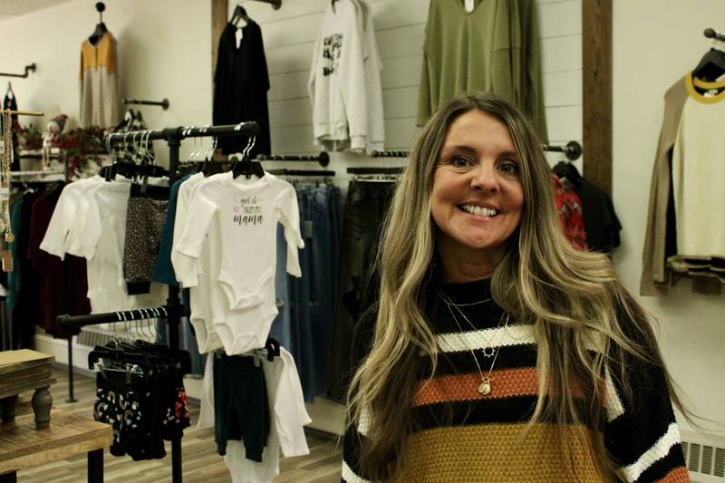 Jenny Koch of J Boutique in Dixon stands in front of the denim display in her women's clothing store. She ordered denim far in advance, anticipating delays in the supply chain, so she was stocked for the winter buying season.