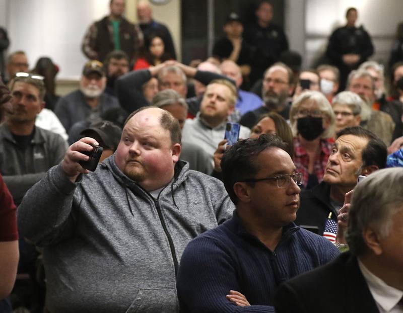 People watch as board members cast their votes on a resolution opposing the Illinois gun ban and supporting its repeal during the McHenry County Board meeting Tuesday, Feb. 21, 2023, in the McHenry County Administration Building.