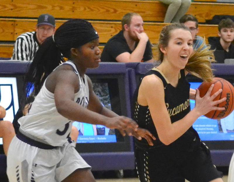 Sycamore's Faith Feuerbach drives the lane as the Hubs' Afi Gati tries to defend.