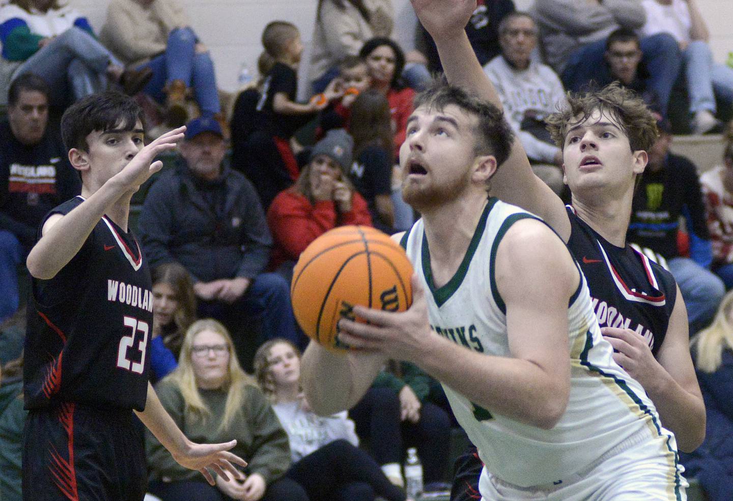 St Bede’s Mason Ross eyes the basket as Woodland’s Nick Plesko and Zander Radke attempt to block his shot in the 1st  period Friday at St Bede.