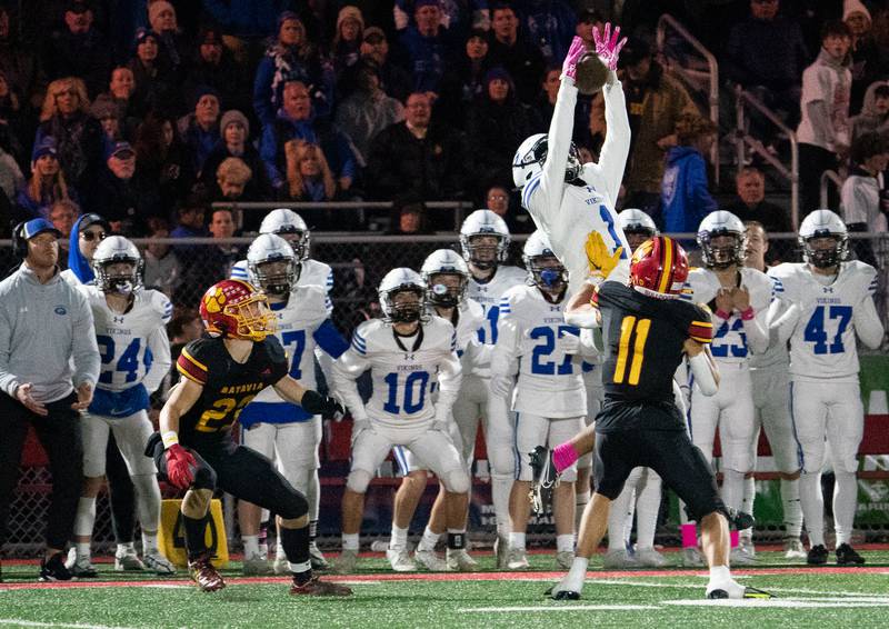 Geneva’s Talyn Taylor (1) leaps to attempt a reception against Batavia’s Gerke Drew (11) during a football game at Batavia High School on Friday, Oct 7, 2022.