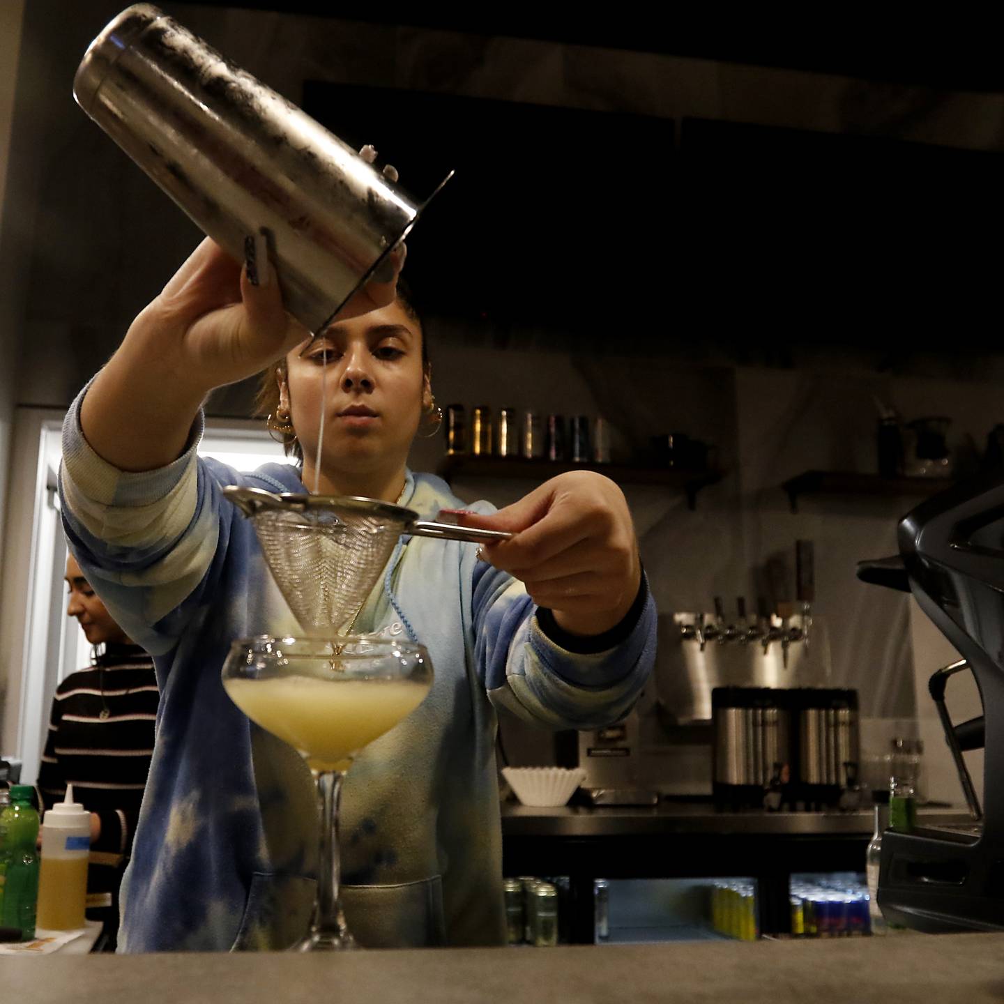 Emily Quintana makes an alcohol-free drink Friday, Oct. 28, 2022, at the Other Side Cafe and Sober Bar, 135 Beardsley St. in Crystal Lake. Chris Reed, who opened the first sober bar in Crystal Lake many years ago, is opening a new one in downtown Crystal Lake. The first bar closed two years ago.