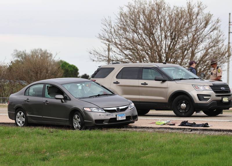 A Honda sedan with a shattered window sits in the westbound lanes of Interstate 88 Monday, April 27, 2026, as police investigate an incident on I-88 just west of Keslinger Road in Maple Park.