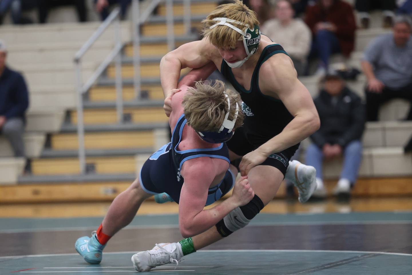 Plainfield Central’s Jack Bowen pulls down Plainfield South’s Kyle McCormick in the 144-pound match on Wednesday, Jan. 8, 2025.