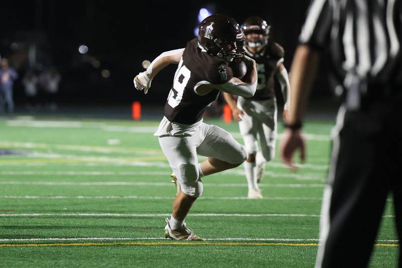 Joliet Catholic’s Keegan Farnaus recovers himself after a missed tackle to score against Providence on Friday, Sept. 1, 2023 Joliet Memorial Stadium.