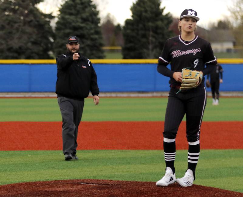 The infield umpire calls Marengo's Alexander Johnson for a bulk in the seven inning scoring Johnsburg's Evan Pohl during a Kishwaukee River Conference baseball game on Monday, April 21, 2025, at Johnsburg High School.