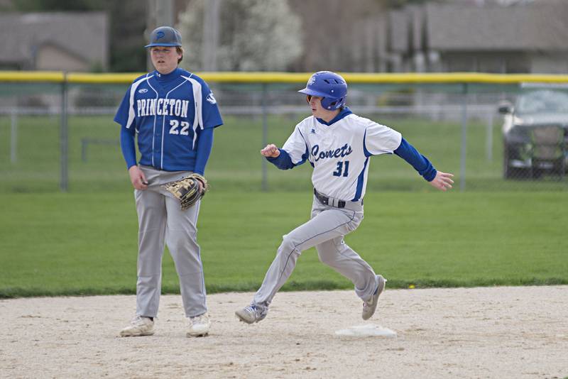 Newman’s Treton Hicks rounds second on his way to third against Princeton Monday, May 2, 2022.