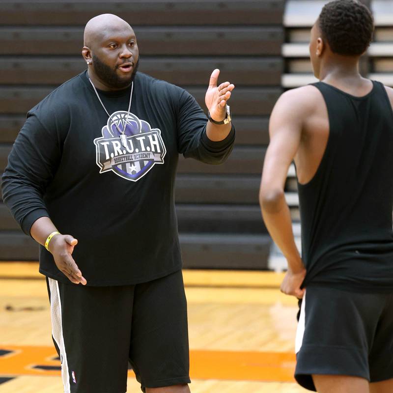 Jay Moore, founder of TRUTH Basketball Academy and an assistant basketball coach at DeKalb High School, gives some coaching to Gabe Crump, 15, from DeKalb, Tuesday, June 25, 2024, during a session at the school.