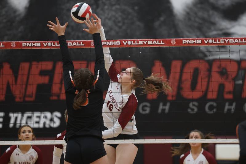 Plainfield North’s Victoria Bouska hits a shot down the line against Plainfield East on Thursday night.