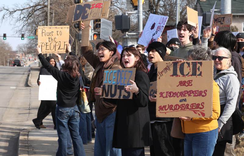 Northern Illinois University students hold signs and chant Friday, Feb 13, 2026, in front of the DeKalb Police Department, during a protest against recent nationwide U.S. Immigration and Customs Enforcement activity.