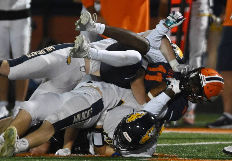 Naperville North’s Brock Pettaway gets tackled by a host of Neuqua Valley defenders during a football game played on Friday, Oct. 11, 2024 in Naperville.