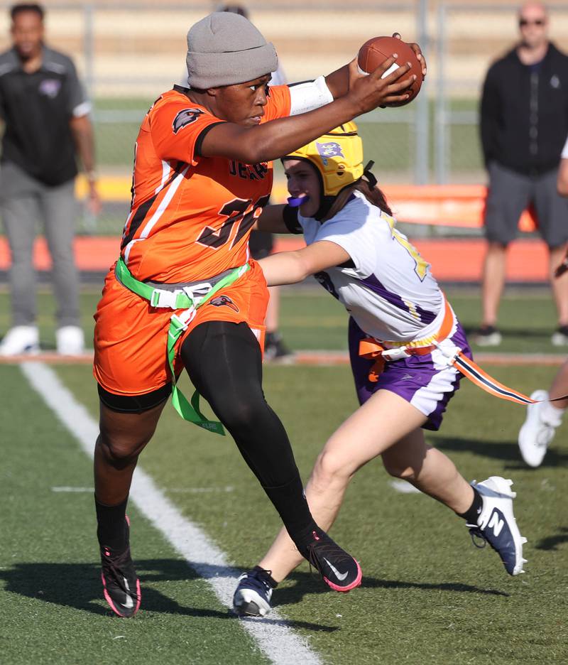 DeKalb's Angela Gary avoids a defender on her way to the endzone Monday, Aug. 25, 2025, during their game against Belvidere at DeKalb High School. The contest marked the first ever game for the girls flag football program at DeKalb.