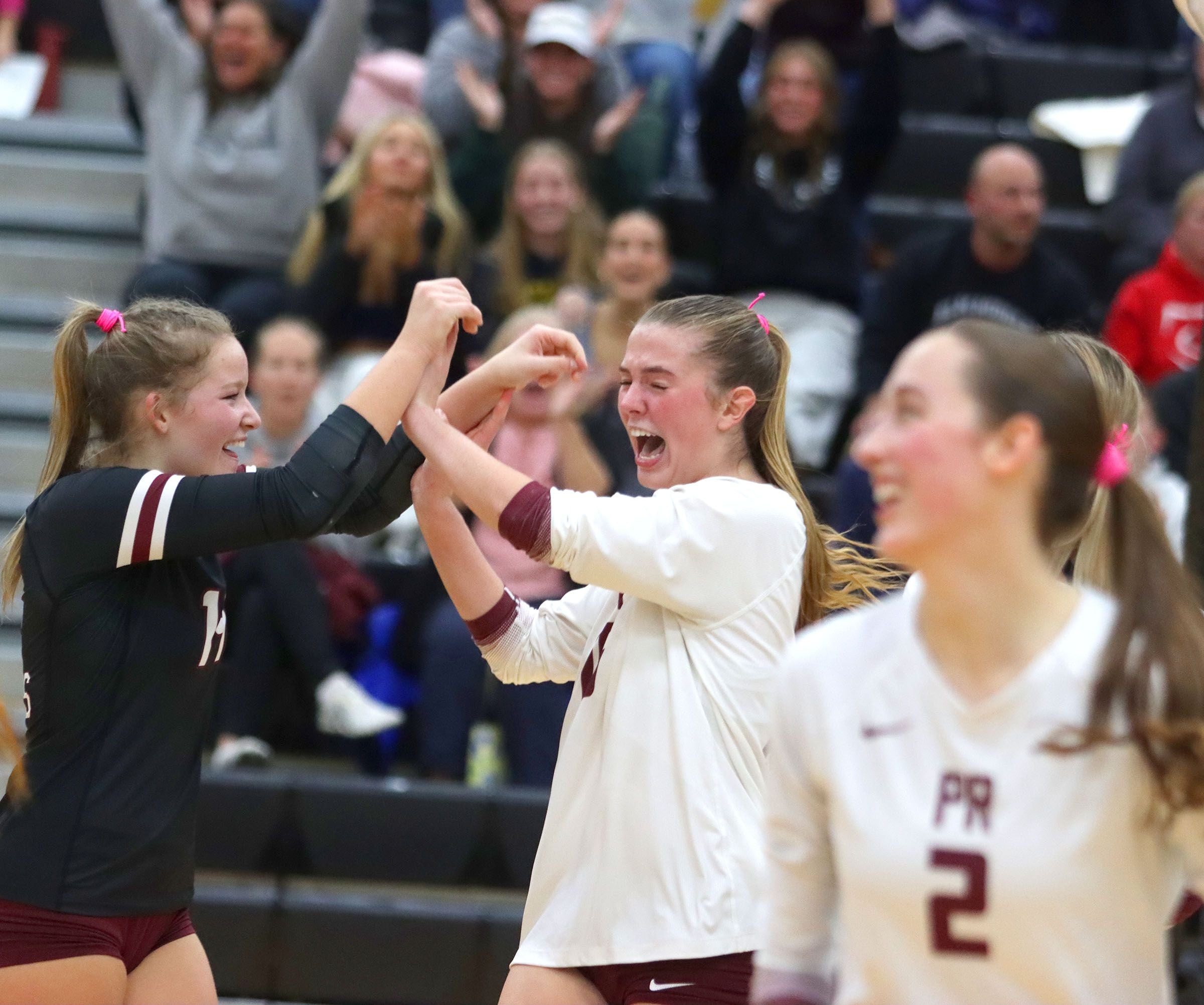 Prairie Ridge’s Tegan Vrbancic, left, and Addy Grider celebrate a late point in a win over St. Viator in IHSA Class 3A Super-Sectional girls volleyball at Streamwood High School in Streamwood on Monday, November 10, 2025.