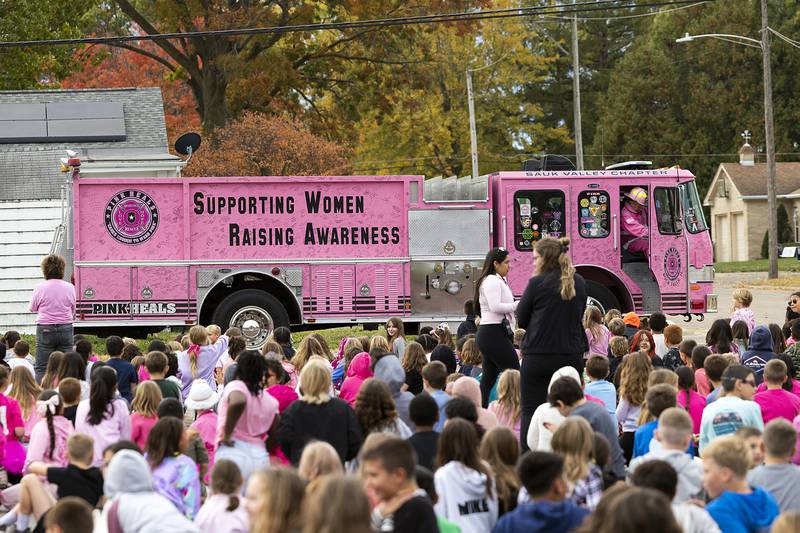With sirens blaring, Pink Heals of the Sauk Valley arrives outside of Washington School Wednesday, Oct. 23, 2024, in support and celebration of teacher’s aid Peggy Craft.