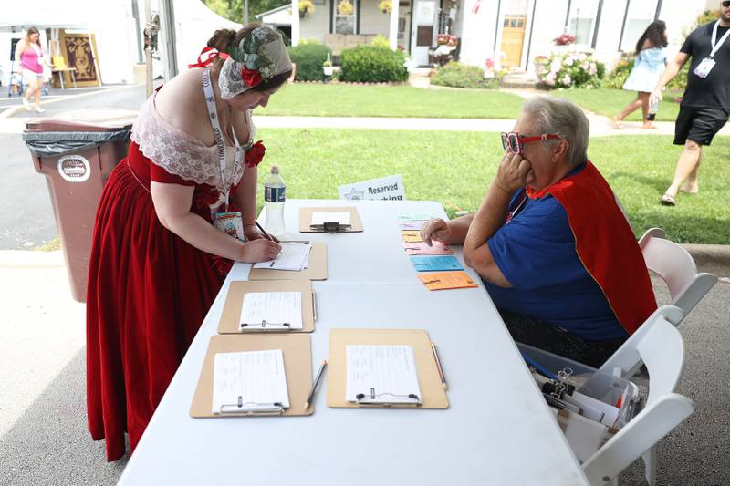 Madison Wyman, left, dressed as a character from Visitations, a comic by Chicago-based artist Scott Larson, signs up for the Cosplay contest at Comicolopis, Lockport’s 7th annual Comic and Fandom Con on Saturday, July 29.