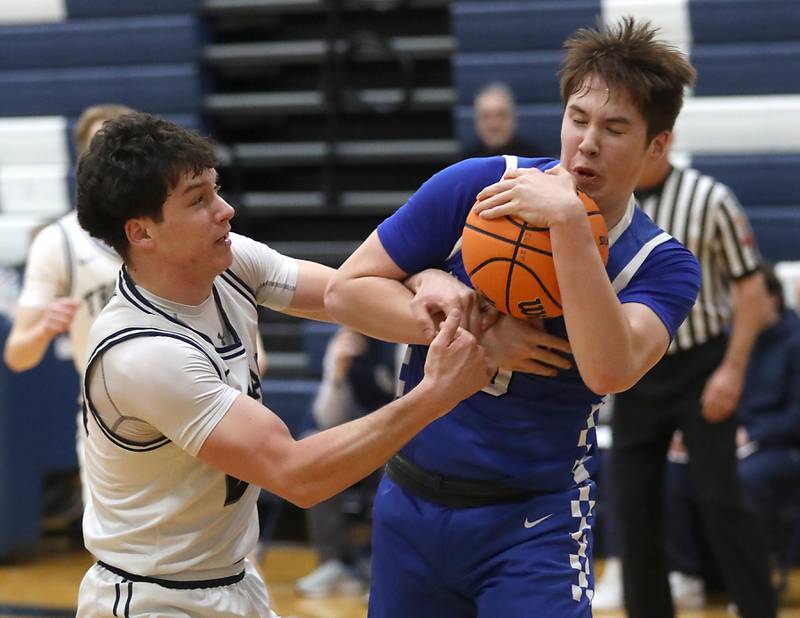 Cary-Grove's Brady Bauer battles with Burlington Central's Colton O'Neil for contriol of the ball during a Fox Valley Conference  boys basketball game on Wednesday Jan. 7,  2026, at Cary-Grove High School, in Cary.